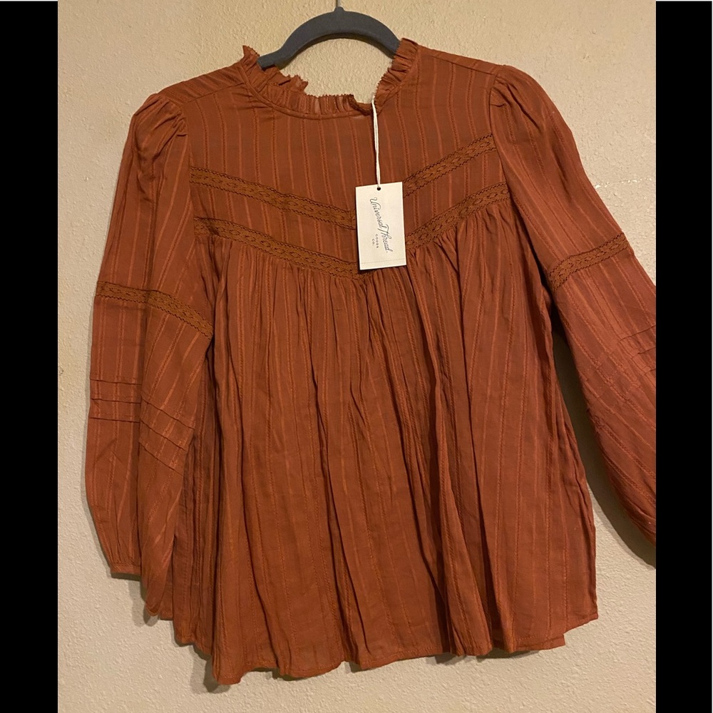 Light brown see-through blouse.